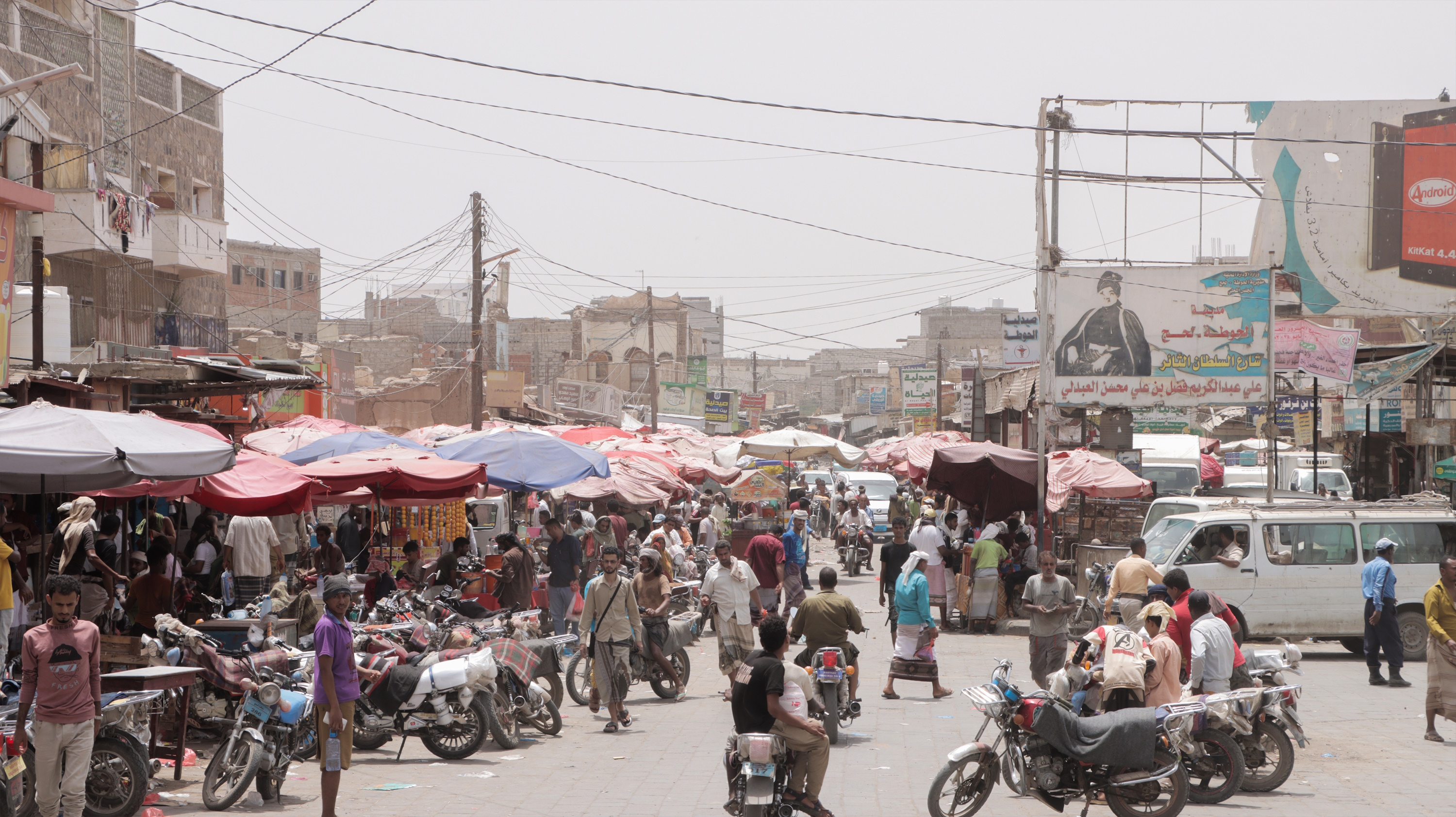 a group of people walking down a busy street