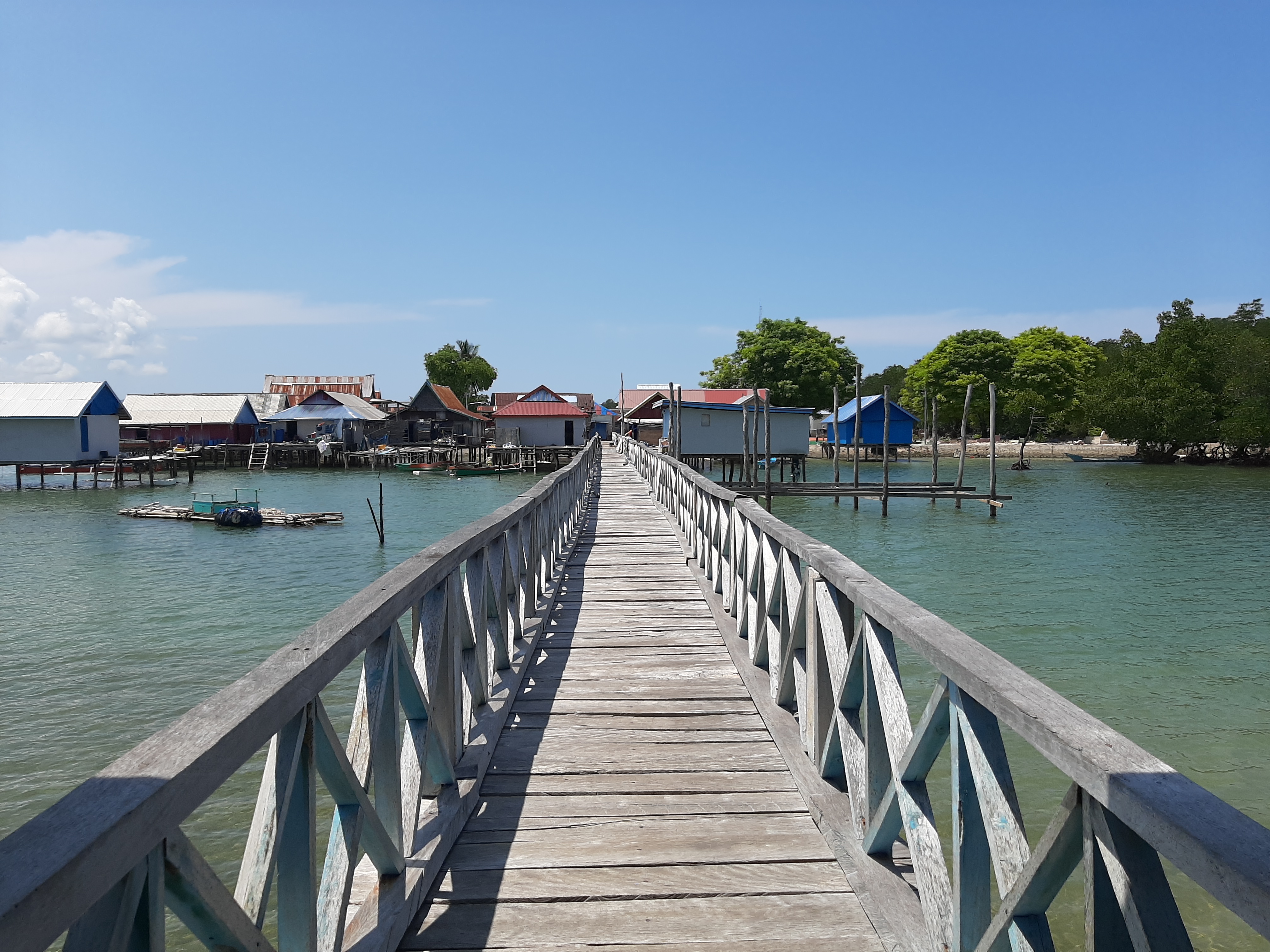 a wooden pier next to a body of water