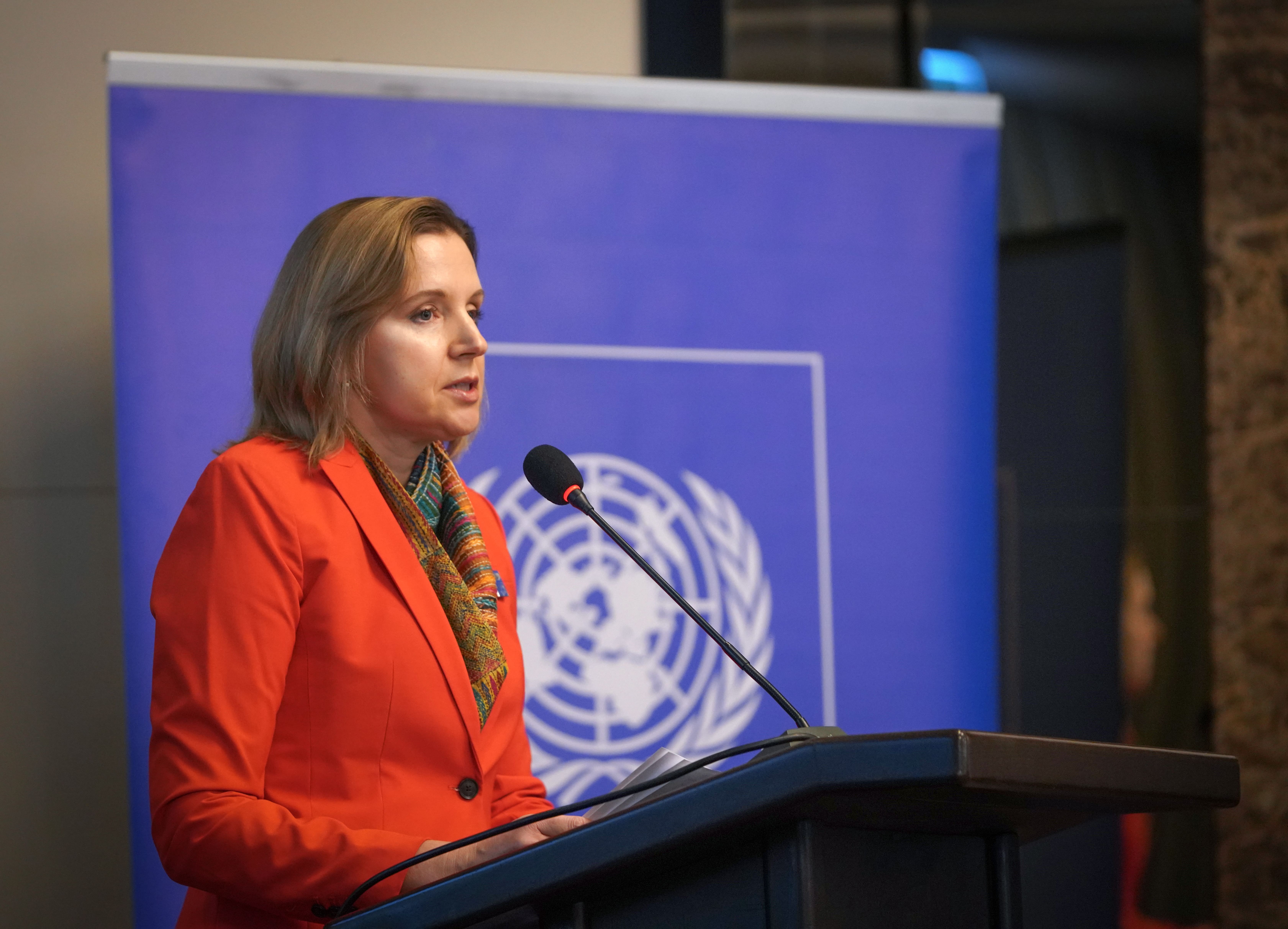 a person standing in front of a mic and giving her speech