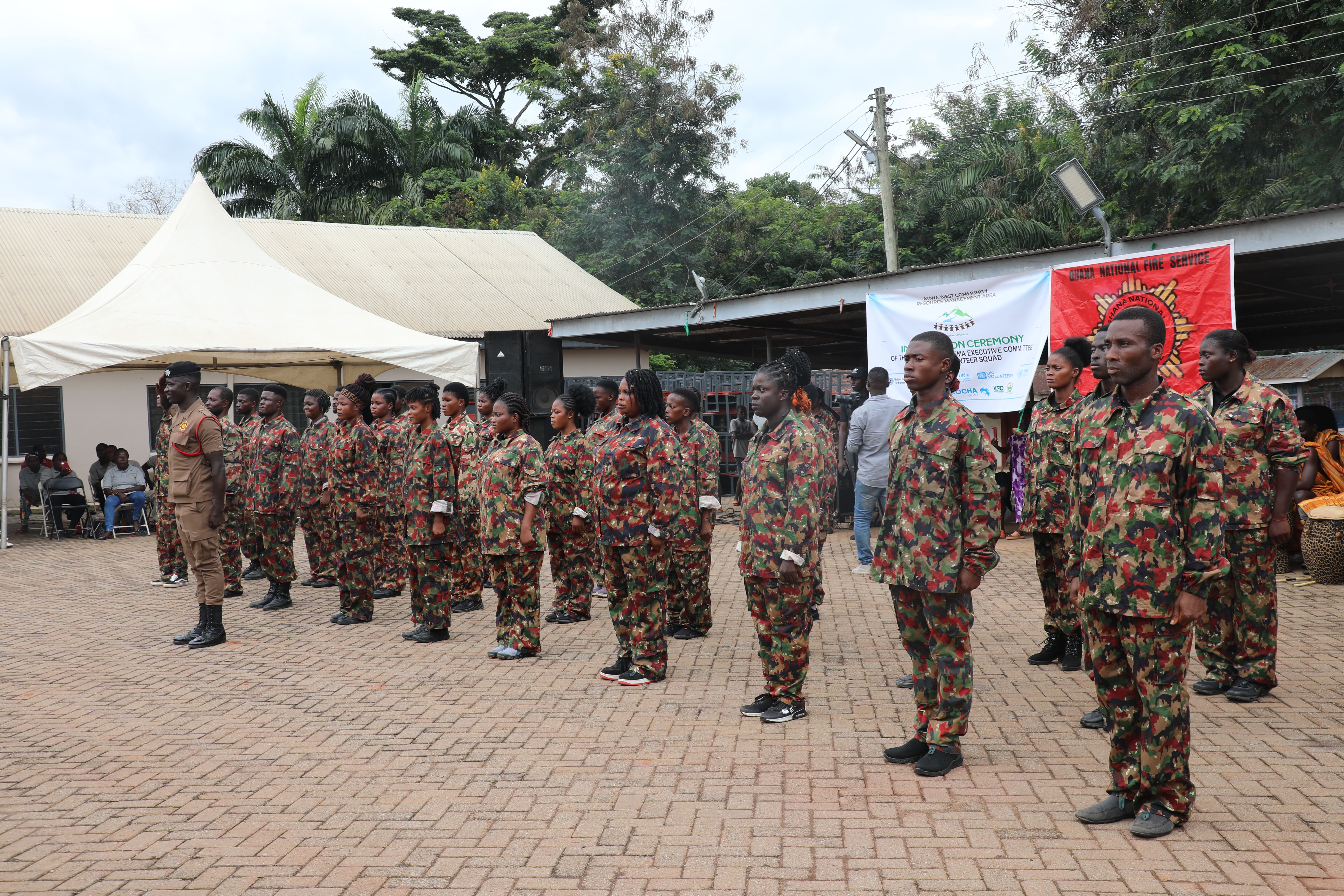 a group of people in military uniform standing in front of a building