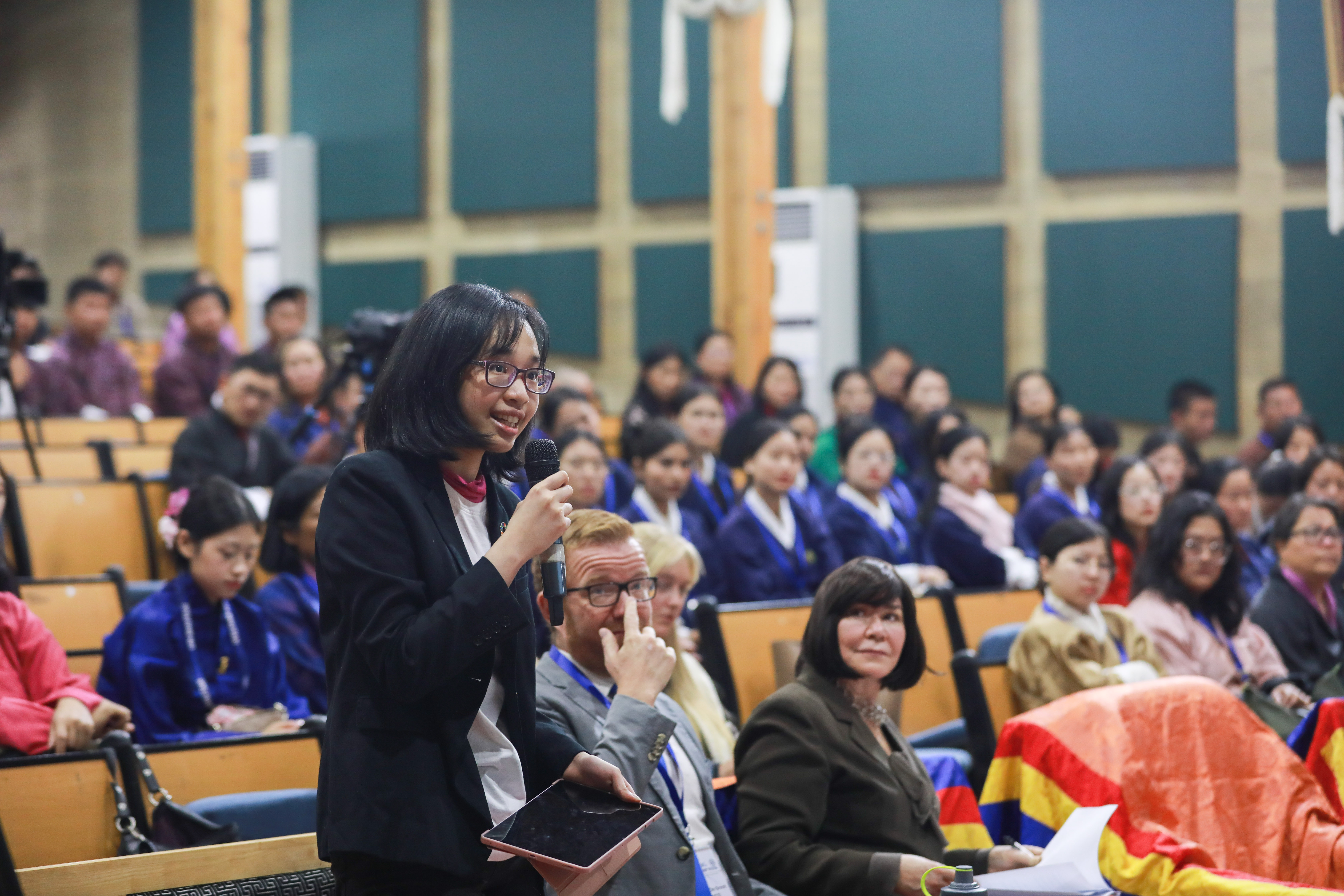 a group of people sitting in front of a crowd